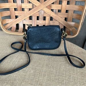 Small leather purse with a long strap for wearing across your chest